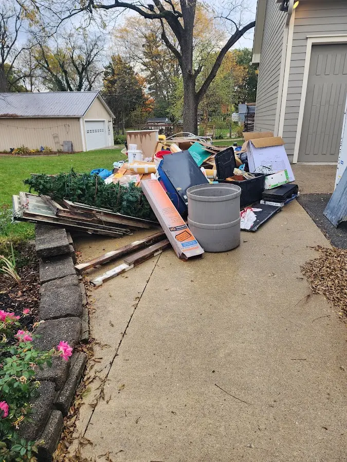 Dumpster being loaded with debris for Estate Cleanout Dumpster Rental in Rayne